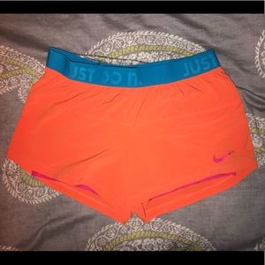 Orange Nike shorts size M with compression under